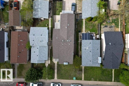 Aerial view showcasing a residential property with a light gray shingle roof and a green lawn - 157 Kiniski Crescent, Edmonton, AB - 