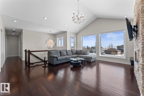 Living area featuring vaulted ceilings, recessed lighting, and expansive windows - 1513 Horseshoe Bay Estates, Cold Lake, AB - Indoor Photo Showing Living Room