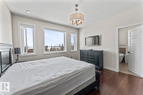 Bedroom featuring dark hardwood flooring, recessed lighting, and a chandelier - 1513 Horseshoe Bay Estates, Cold Lake, AB - Indoor Photo Showing Bedroom