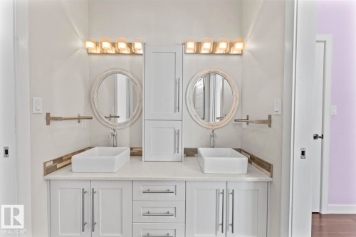 This bathroom features a double vanity with white cabinetry, a light-colored countertop, and two rectangular vessel sinks - 1513 Horseshoe Bay Estates, Cold Lake, AB - Indoor Photo Showing Bathroom