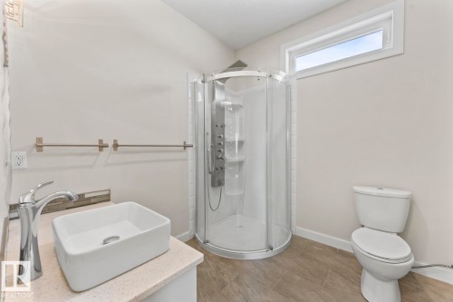 Bathroom featuring a modern shower enclosure, a white vessel sink with a chrome faucet, and a horizontally oriented window - 1513 Horseshoe Bay Estates, Cold Lake, AB - Indoor Photo Showing Bathroom