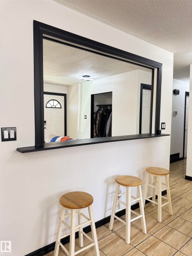 Pass-through window with black trim, integrated shelf, and tile flooring - 45 Lambert Crescent, St. Albert, AB - Indoor