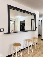 Pass-through window with black trim, integrated shelf, and tile flooring - 