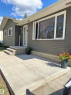 Contemporary exterior featuring dark gray horizontal siding and white trim - 