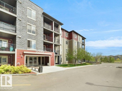 Multi-story building featuring stacked stone and horizontal siding - 216 5390 Chappelle Road, Edmonton, AB - Outdoor With Balcony With Facade