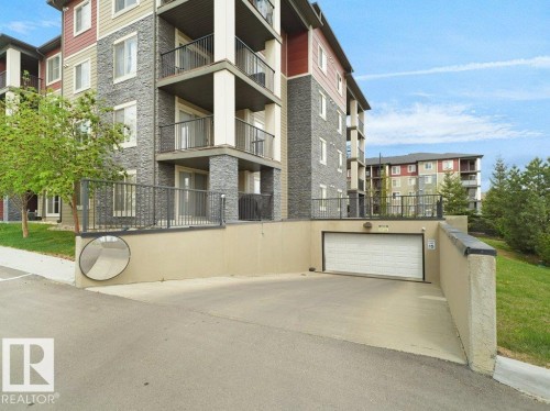 Modern multi-story building featuring stone veneer and horizontal siding - 216 5390 Chappelle Road, Edmonton, AB - Outdoor With Balcony