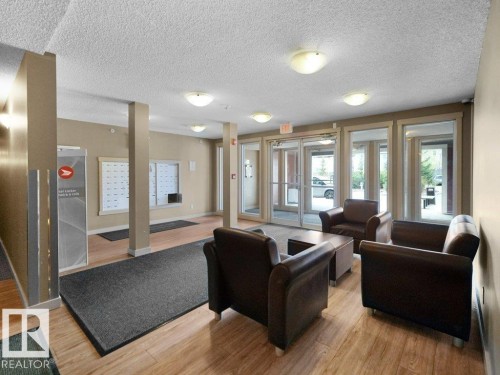 Lobby area featuring wood-finish flooring, recessed lighting, and a mailroom with individual mailboxes - 216 5390 Chappelle Road, Edmonton, AB - Indoor