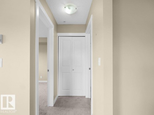 Hallway with light beige walls and light gray carpet - 216 5390 Chappelle Road, Edmonton, AB - Indoor Photo Showing Other Room