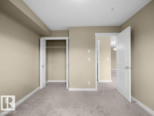 Neutral tone walls, light-colored carpet, and white trim - 216 5390 Chappelle Road, Edmonton, AB - Indoor Photo Showing Other Room