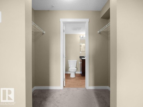 Walk-through closet with carpeting and built-in wire shelving - 216 5390 Chappelle Road, Edmonton, AB - Indoor