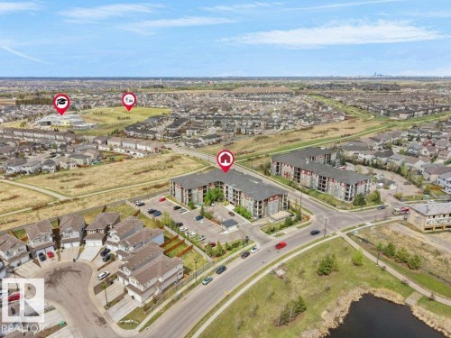 Aerial perspective showcasing a residential area with detached homes and multi-story apartment buildings - 216 5390 Chappelle Road, Edmonton, AB - Outdoor With View