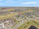 Aerial perspective showcasing a residential area with detached homes and multi-story apartment buildings - 216 5390 Chappelle Road, Edmonton, AB  - Outdoor With View 