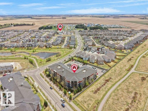 Aerial perspective showcasing a developed residential area with multiple housing types - 216 5390 Chappelle Road, Edmonton, AB - Outdoor With View