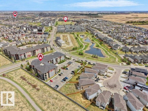 Aerial perspective showcasing residential buildings amidst a developed community - 216 5390 Chappelle Road, Edmonton, AB - Outdoor With View