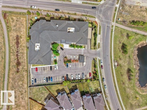 Commercial building featuring ample surface parking, multiple roof sections, and surrounding roadways - 216 5390 Chappelle Road, Edmonton, AB - Outdoor With View