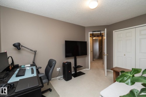 Neutral tone wall paint, textured ceiling, and carpeted flooring - 9112 166 Avenue, Edmonton, AB - Indoor