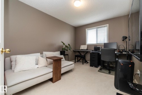 Windowed room with neutral-toned walls, textured ceiling, and a light-colored carpet - 9112 166 Avenue, Edmonton, AB - Indoor Photo Showing Office