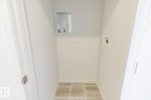 Dedicated utility space featuring tile flooring - 3613 Triomphe Boulevard N, Beaumont, AB - Indoor Photo Showing Other Room