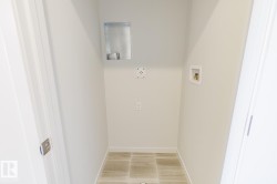 Dedicated utility space featuring tile flooring - 