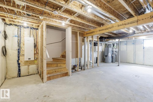 Unfinished basement presenting open joist ceilings, exposed framing, and a concrete floor - 3613 Triomphe Boulevard N, Beaumont, AB - Indoor Photo Showing Basement
