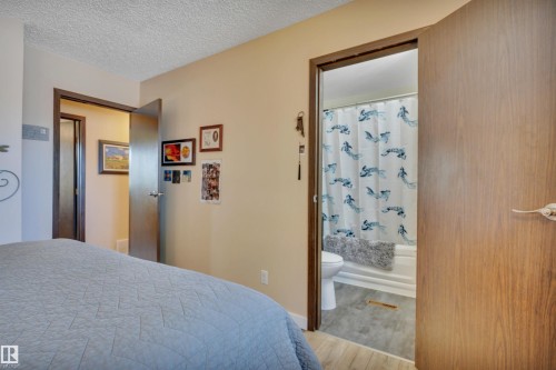 Bedroom area featuring neutral wall tones and wood-finish doors - 112 Oak Drive, Wetaskiwin, AB - Indoor Photo Showing Bedroom