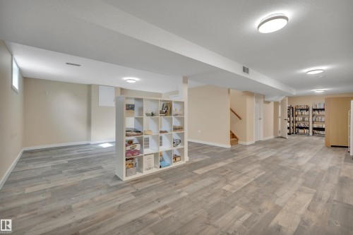 Expansive finished lower level featuring wood-finish flooring, recessed lighting, and a neutral color palette - 112 Oak Drive, Wetaskiwin, AB - Indoor Photo Showing Other Room