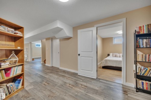 Spacious interior room with wood-finish flooring, neutral wall paint, white trim, and recessed lighting - 112 Oak Drive, Wetaskiwin, AB - Indoor