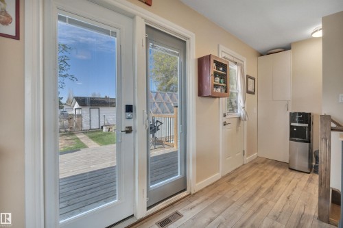 Glass panel double doors opening to an outdoor deck - 112 Oak Drive, Wetaskiwin, AB - Indoor Photo Showing Other Room