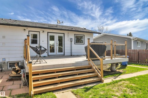Rear exterior featuring a spacious composite deck with wooden railings - 112 Oak Drive, Wetaskiwin, AB - Outdoor With Deck Patio Veranda