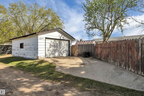 Detached garage with a single bay door, small side window, and a concrete driveway - 112 Oak Drive, Wetaskiwin, AB - Outdoor