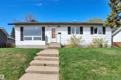 White siding exterior with black shutters and a prominent front window - 112 Oak Drive, Wetaskiwin, AB - Outdoor