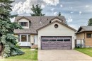 Two-story residence featuring dormer windows and a front-facing garage with a concrete driveway - 9528 189 Street, Edmonton, AB  - Outdoor With Facade 