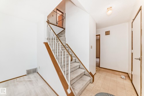 Staircase featuring white balusters and wood-finish handrails - 9528 189 Street, Edmonton, AB - Indoor Photo Showing Other Room