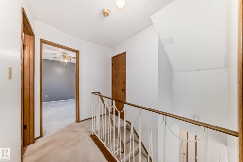 Upper-level hallway with textured ceiling and a single ceiling light fixture - 9528 189 Street, Edmonton, AB - Indoor Photo Showing Other Room