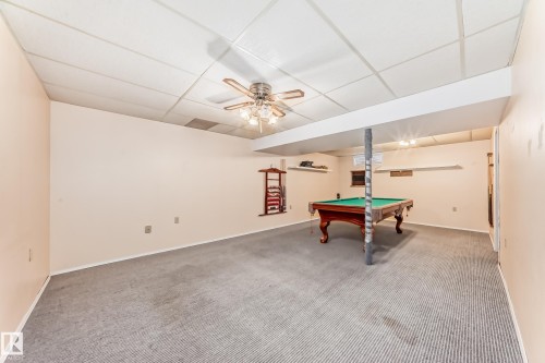 Spacious room featuring neutral-toned walls and striped carpeting - 9528 189 Street, Edmonton, AB - Indoor Photo Showing Other Room