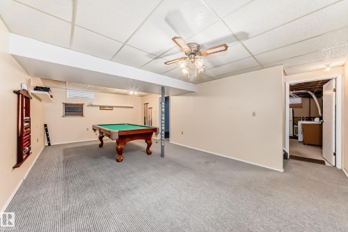 Spacious finished basement featuring carpeted flooring, drop ceiling, recessed lighting, and a ceiling fan - 9528 189 Street, Edmonton, AB - Indoor Photo Showing Other Room