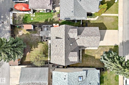 Aerial perspective showcasing a property with a light grey shingle roof, a concrete driveway, and a partially paved backyard area - 9528 189 Street, Edmonton, AB - Outdoor