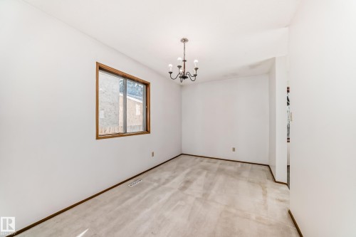 Room featuring light-toned carpeting, white walls, and dark wood-tone trim - 9528 189 Street, Edmonton, AB - Indoor Photo Showing Other Room