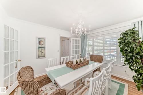 Dining area with wood-finish flooring and crown molding - 11115 44 Street, Edmonton, AB - Indoor Photo Showing Dining Room