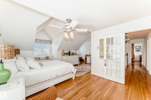 Bedroom with vaulted ceilings and wood-finish flooring - 11115 44 Street, Edmonton, AB - Indoor Photo Showing Bedroom