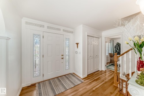 Entryway featuring a paneled door with decorative glass sidelights, transom windows, and crown molding - 11115 44 Street, Edmonton, AB - Indoor Photo Showing Other Room