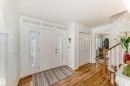Entryway featuring a paneled door with decorative glass sidelights, transom windows, and crown molding - 11115 44 Street, Edmonton, AB  - Indoor Photo Showing Other Room 