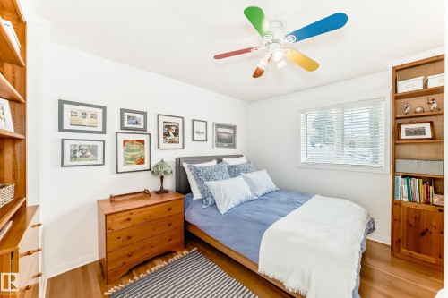 Bright room featuring wood-finish flooring and white walls - 11115 44 Street, Edmonton, AB - Indoor Photo Showing Bedroom