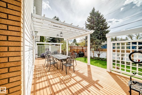 Expansive wooden deck featuring a white pergola structure - 11115 44 Street, Edmonton, AB - Outdoor With Deck Patio Veranda With Exterior