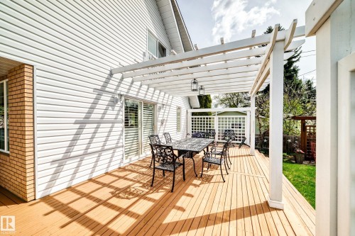 Expansive wooden deck featuring a white pergola structure - 11115 44 Street, Edmonton, AB - Outdoor With Deck Patio Veranda With Exterior