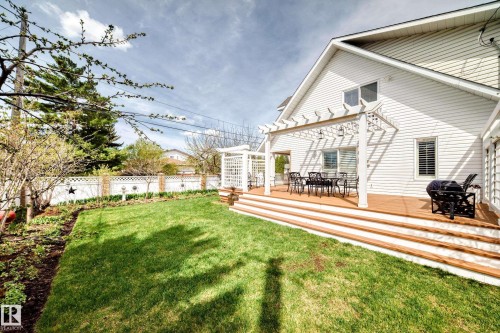 Spacious rear yard featuring a manicured lawn and a multi-level wood deck - 11115 44 Street, Edmonton, AB - Outdoor With Deck Patio Veranda