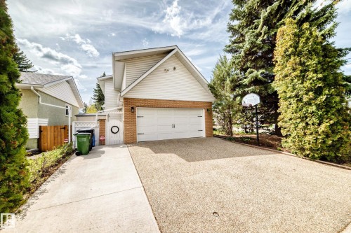 Attached two-car garage with white paneled door - 11115 44 Street, Edmonton, AB - Outdoor