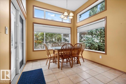 Spacious dining area featuring vaulted ceilings and extensive window placements - 11824 13 Avenue, Edmonton, AB - Indoor Photo Showing Dining Room