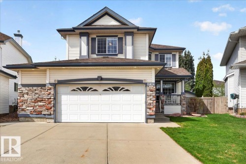 Two-story residence featuring light-colored siding and dark trim accents - 11824 13 Avenue, Edmonton, AB - Outdoor
