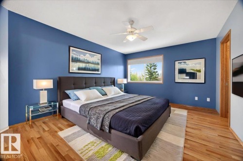 Hardwood flooring and a ceiling fan with integrated lighting - 11824 13 Avenue, Edmonton, AB - Indoor Photo Showing Bedroom